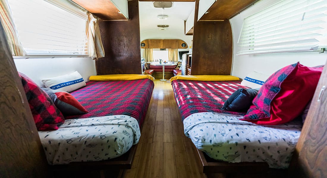 Two twin beds with red and black check quilts