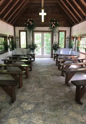 Inside of Wedding Chapel Wooden Benches Stained Glass Cross