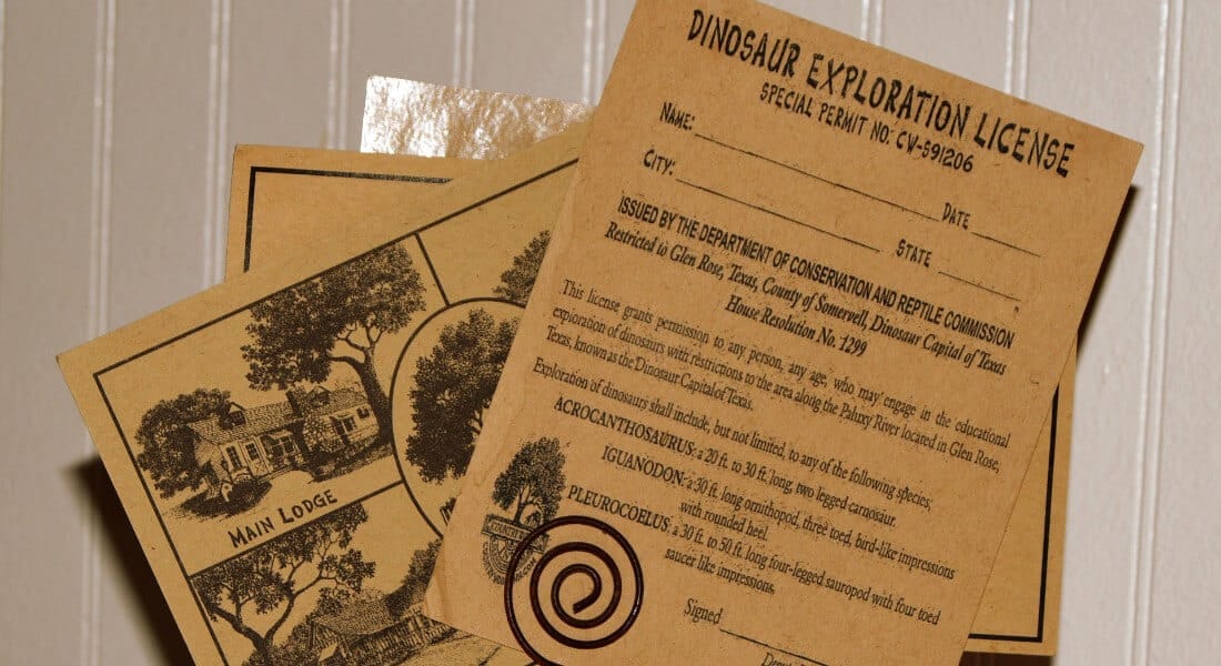 "Dinosaur Exploration License" held together in a clip. 